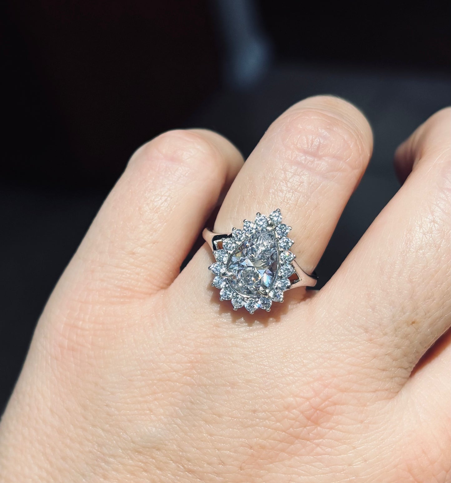 Sterling silver 4ct pear zirconia ring w/halo setting. Ring is adjustable sizing in back