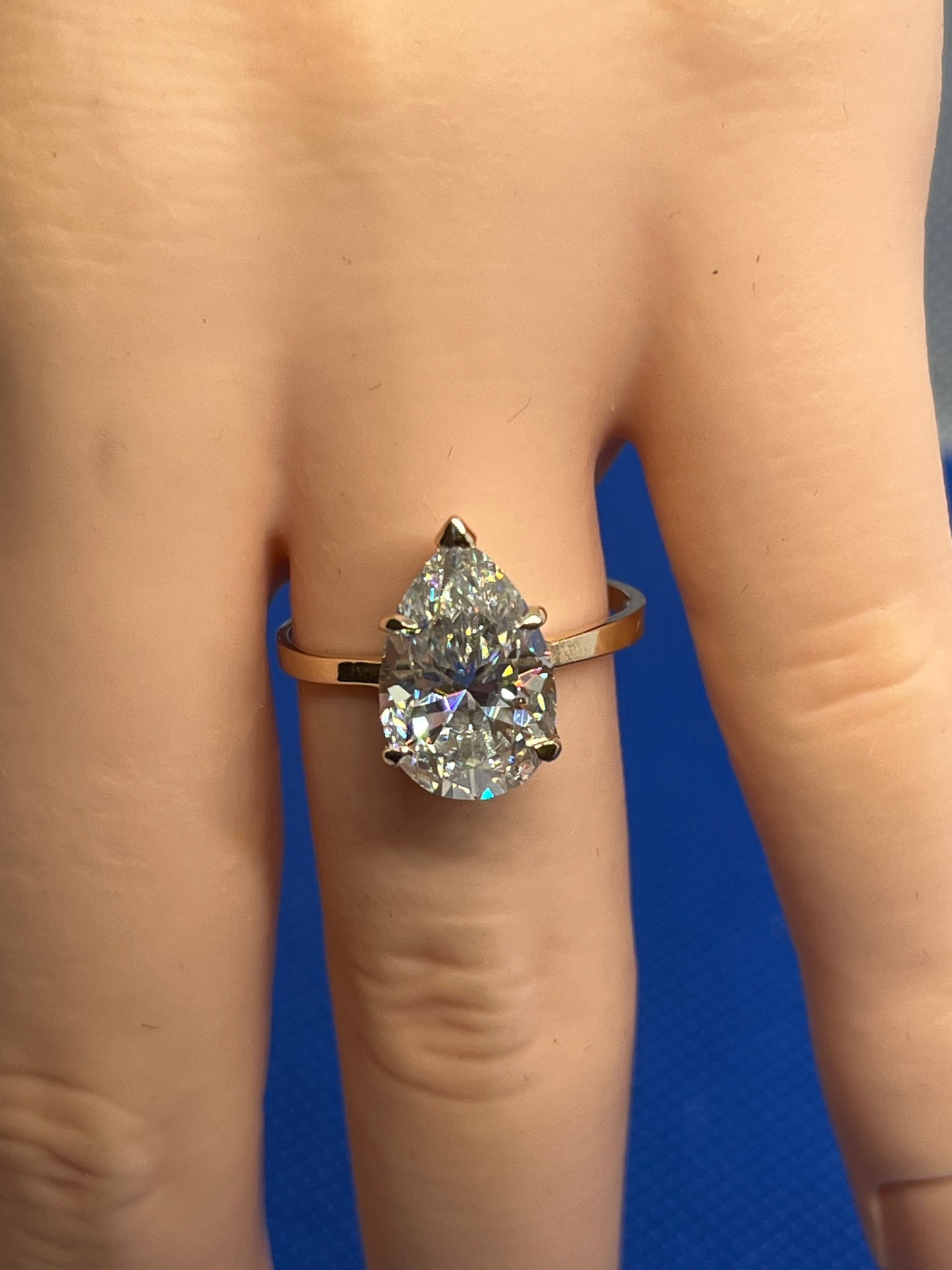 14k solid yellow gold ring with a 4ct GRA pear shaped moissanite