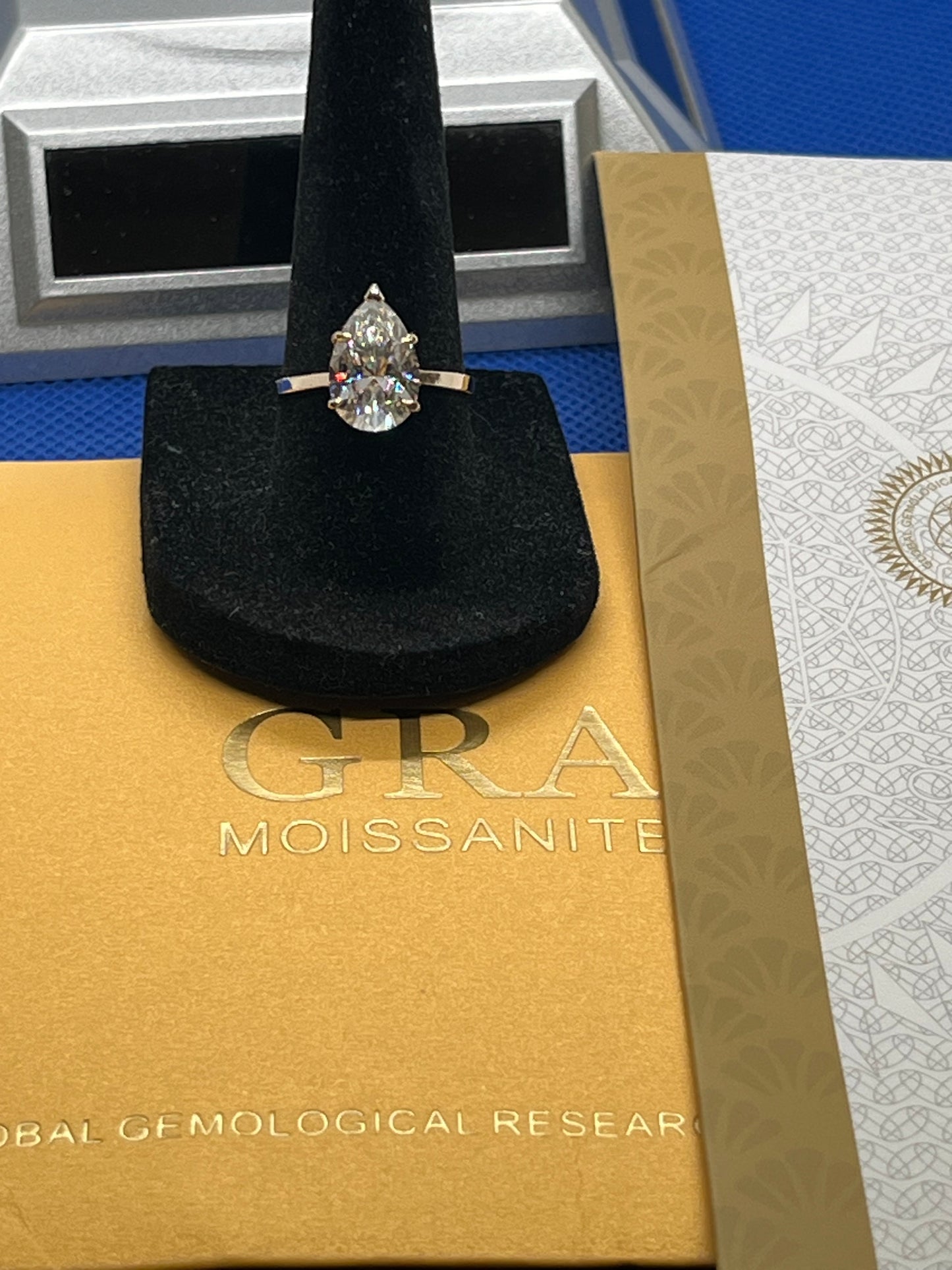 14k solid yellow gold ring with a 4ct GRA pear shaped moissanite